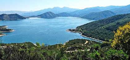 A panoramic view of a lake surrounded by mountains — the beauty of God's creation in landscapes like this echoes Psalm 121: "I will lift up mine eyes unto the hills, from whence cometh my help."