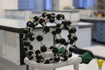 A buckyball (Buckminsterfullerene) molecule model shows 60 carbon atoms arranged in a perfect sphere — the same shape as a soccer ball! This amazing molecule was discovered in 1985 and named after architect Buckminster Fuller.